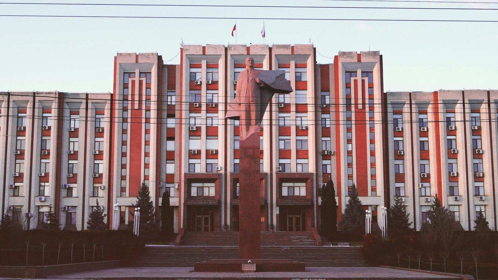 Long modernist Tiraspol facade with rows of narrow windows along the central boulevard. Long modernist Tiraspol facade with rows of narrow windows along the central boulevard.